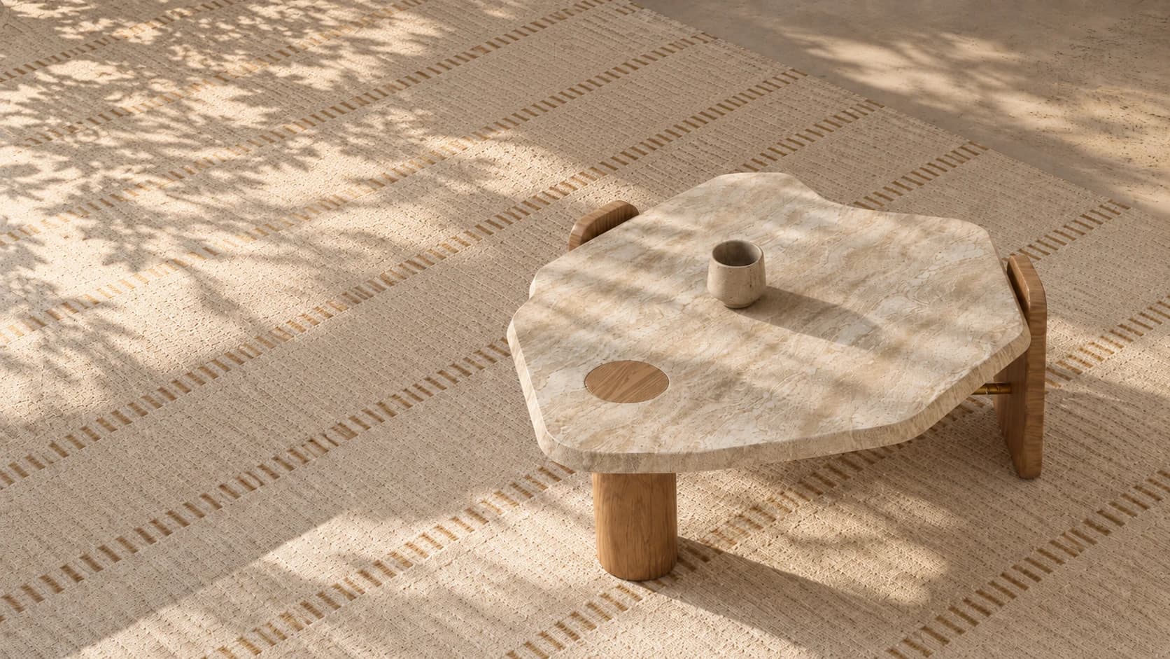 Nuvé sculpted stone coffee table on a woven rug